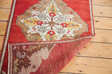Vintage Oushak runner corner displaying cherry red pile and hand-knotted weave.