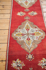 Swirling bronze and ivory medallion with saffron yellow details on a cherry red Oushak runner.