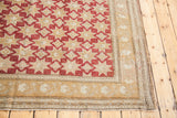 Hand-knotted border of the vintage Oushak carpet with ivory curvilinear patterns and fringe.