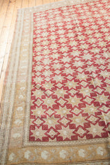 Cranberry red star pattern meets the stylized neutral border of a vintage Oushak rug.