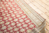 Geometric cranberry wine-red field and bronze ivory striped border of vintage Oushak carpet.