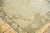 Corner view of Vintage Oushak rug, showing subtle earth tones and charcoal-brown border.