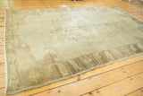 Subtle grey field and charcoal-brown border with delineated patterns on a vintage Oushak rug.