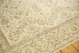 Faded allover curvilinear pattern and subtle earth-tone border on a vintage Oushak rug.