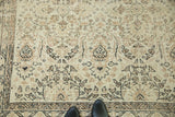 Distressed vintage Oushak carpet, showing soft pile and muted earth-tone allover pattern.