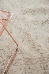 Blanched ivory and subtle mint tones on a faded floral vintage Oushak carpet.