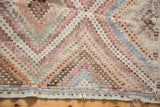 Soft pastel diamond motifs, staggered knotting, and blue stripe on Vintage Jajim rug's edge.