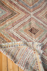Reverse weave structure and pastel diamond pattern of a vintage Jajim rug.