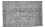 Distressed vintage Oushak carpet with faded bronzy-beige and slate gray central medallion.