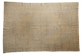 Distressed Oushak carpet in soft beige and slate green with a faded medallion design.