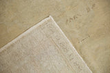 Soft beige and slate green distressed Oushak pile, revealing the rug's sturdy woven foundation.