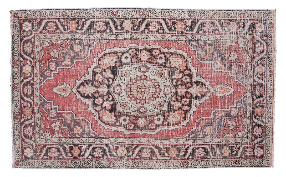 Vintage Oushak rug featuring a cinnabar red field with charcoal medallion and ornate border.