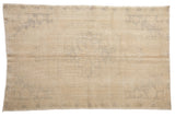 Soft blanched vintage Oushak rug featuring a faded central medallion design, 4'9