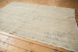 Distressed texture and soft blanched pattern details on a vintage Oushak rug.
