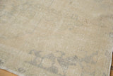 Soft blanched tones and distressed texture of the vintage Oushak rug.
