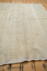 Softly distressed fringe and light blanched edge of the vintage Oushak rug.