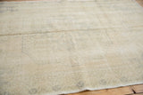 Close-up detail of distressed Oushak rug pile with blanched tones and faded patterns.