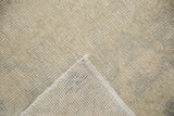 Hand-knotted foundation and soft blanched pile texture of the distressed Oushak rug.