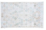 Distressed modern Oushak rug: scattered teal, aqua, and pastel motifs on airy ivory, 4x6.7 feet.