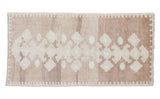 Vintage minimalist Oushak runner featuring geometric tone-on-tone pattern in light beige.