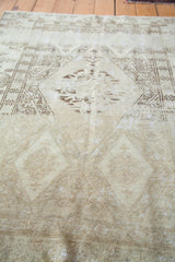 Textured distressed pile of the Oushak rug in tone-on-tone beige and subtle patterns.