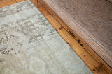 Muted cream and soft brown tone-on-tone design on a distressed Oushak rug.