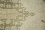 Stylized tone-on-tone beige and ivory pattern with seafoam green overcast on a vintage Oushak rug.