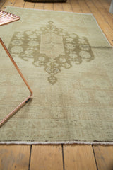 Tone-on-tone medallion motif on a vintage Oushak rug in ivory with a sea foam green overcast.