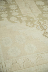 Curvilinear pattern in soft ivory, beige, and sea foam green on the vintage Oushak rug.