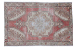Distressed Oushak rug featuring a cranberry red field, powder blue medallion, and ivory-grey details.