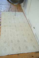 Sun-faded blanched look of a distressed modern Oushak rug's cypress tree motif.