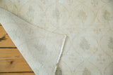 Distressed Oushak rug with hand-knotted foundation and faded cypress tree design.