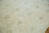 Blanched beige pile of a distressed Modern Oushak runner with faint cypress motifs.