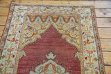 Vintage Oushak runner detail: cinnabar red field, ivory arch with orange stylized florals.