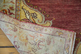 Corner of vintage Oushak rug, showing rich cinnabar red pile and tightly hand-knotted backing.