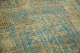 Decorative distressed texture and geometric pattern in blue-green, charcoal, and ivory.