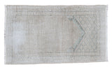 Distressed Oushak rug, soft ivory grey field with subtle faded green pattern.