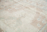 Textured pile of a vintage Turkish Oushak rug with sandy beige and muted tones.