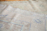 Hand-knotted back of the vintage Oushak rug with sandy beige foundation and blue knots.