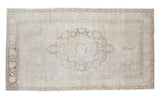 Vintage Oushak carpet with faded bronze medallion and blanched peach tones, 5'1