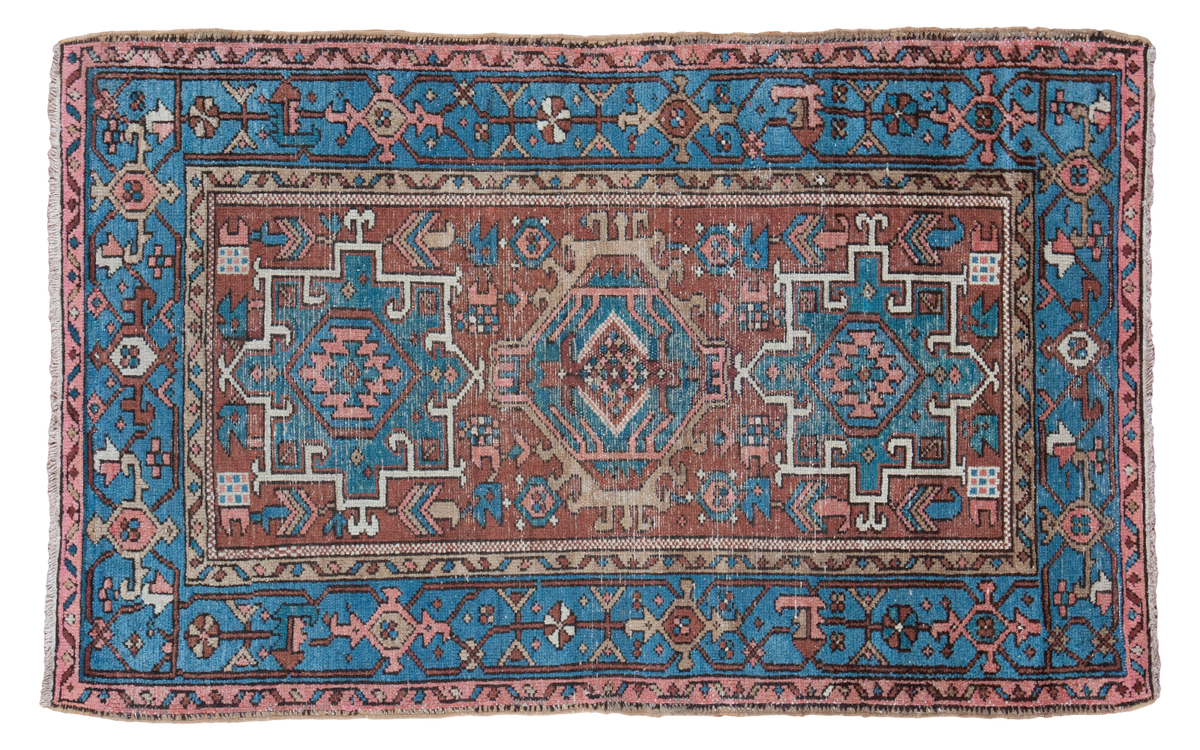 Vintage Persian Karaja rug with brick red field, mallard green medallions, and sky blue geometric border.