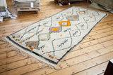 Vintage Moroccan rug runner with textured pile, charcoal side, and colorful diamond motifs.