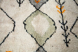Shaggy pile texture of vintage Moroccan runner, with pale gray diamonds and charcoal plant motifs on ivory.