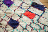Shaggy texture of the vintage Moroccan rug, with hot red, purple, royal blue, and teal diamonds.