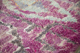 Deep shaggy pile of vintage Moroccan rug with eggplant purple, light blue, and charcoal grey.