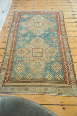 Vintage Anatolian Caucasian rug's soft fringe and rust geometric border detail.