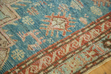 Close-up of vintage Anatolian Caucasian rug's aqua blue geometric design and terracotta border.