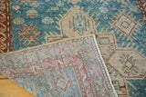 Vintage Anatolian Caucasian rug folded, revealing aqua blue geometric pile and its hand-knotted reverse.
