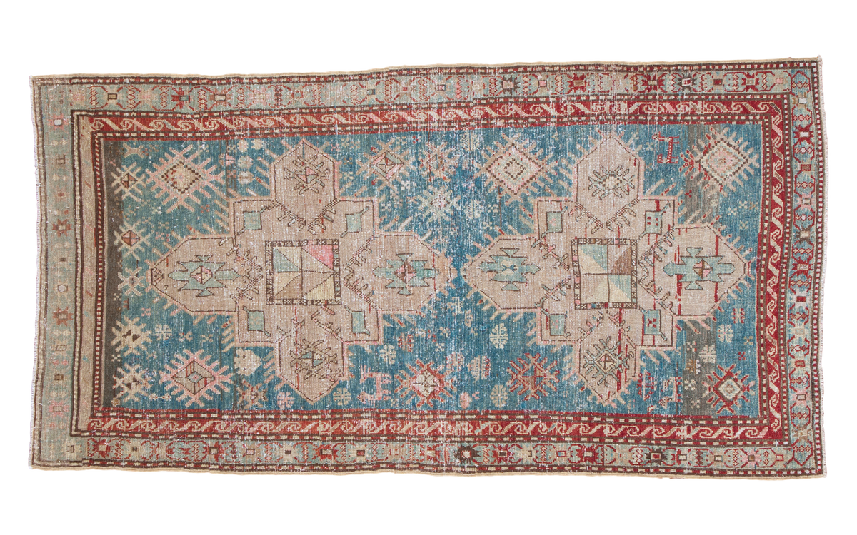 Vintage Anatolian Caucasian rug, aqua blue field with central geometric motifs and muted red borders.