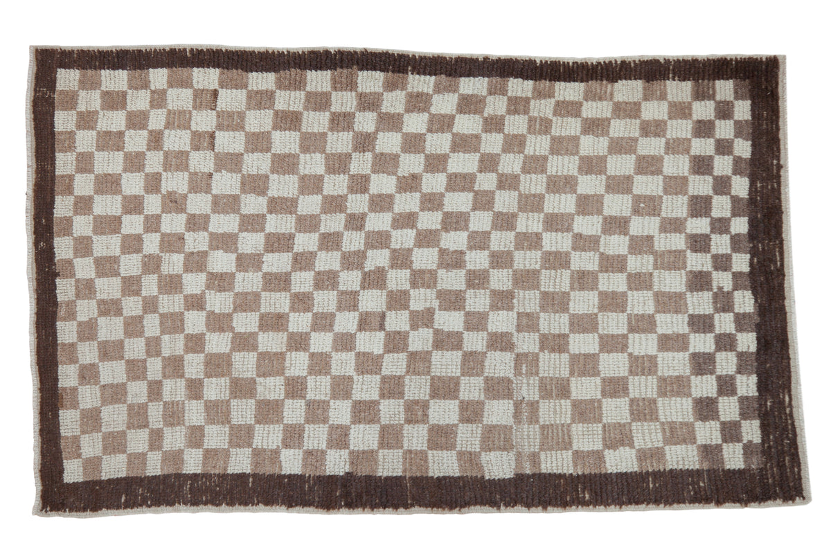 Vintage Tulu rug with blanched ivory and light brown checkered pattern, dark charcoal border.